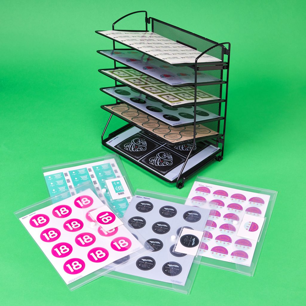 A wire file rack is repurposed to store and organize sheet labels.