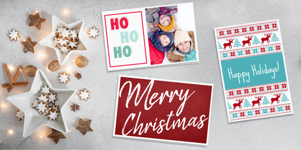 Last minute holiday cards made with Avery predesigned templates and printable cards. The Christmas cards are shown on a white background with wooden stars, cinnamon sticks and walnuts arranged with festive white Christmas lights.