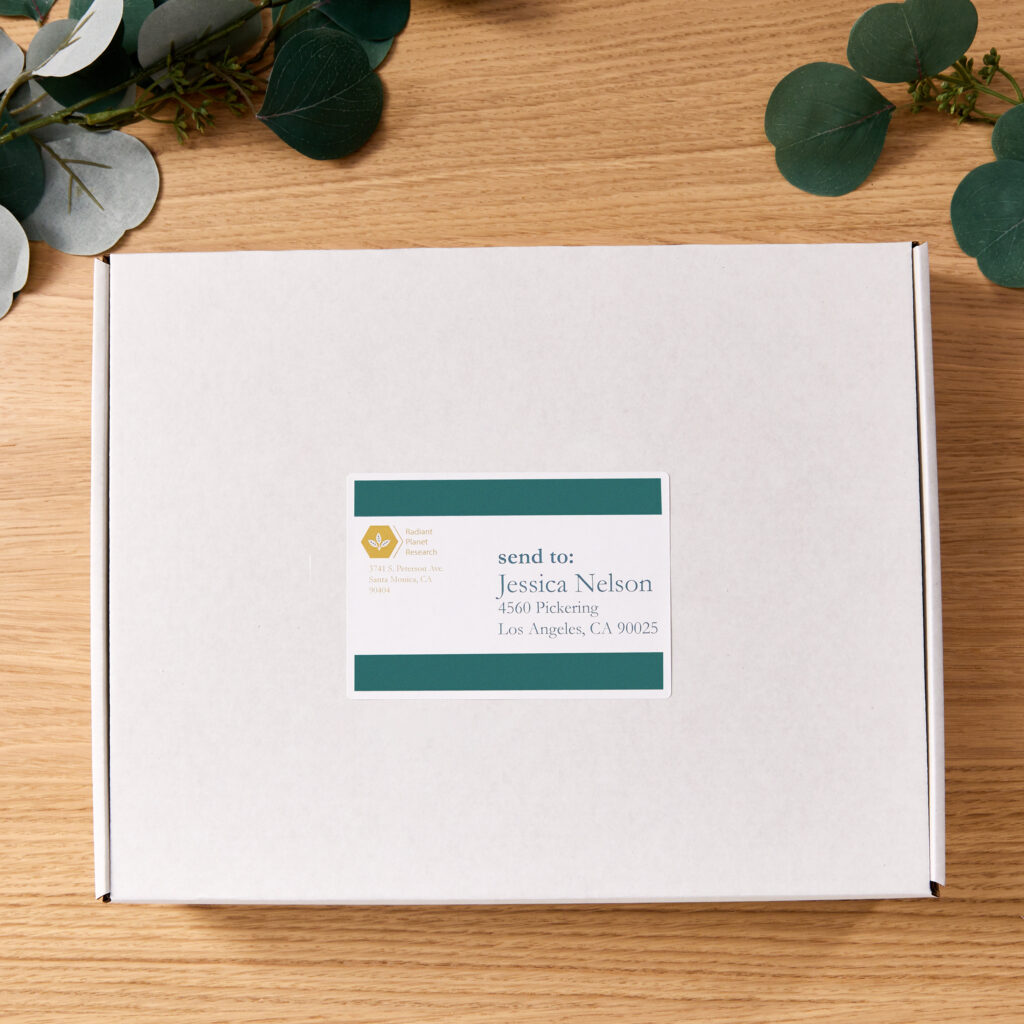 A white box labeled with an Avery shipping label custom-printed with a chic Avery template design.