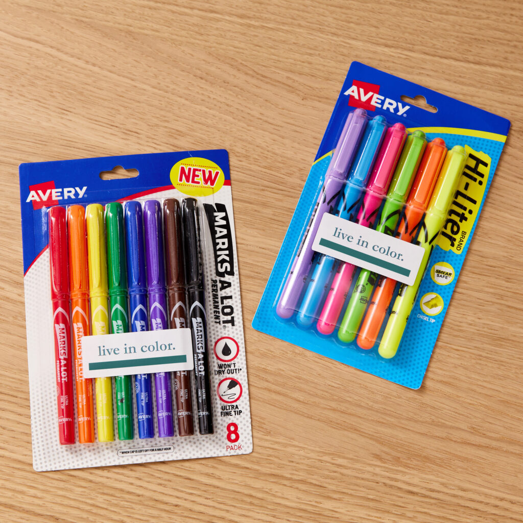 Two multicolored packs of Avery Hi-Liters and Avery Marks-A-Lot Markers with custom-printed Avery labels sitting on a wood surface.