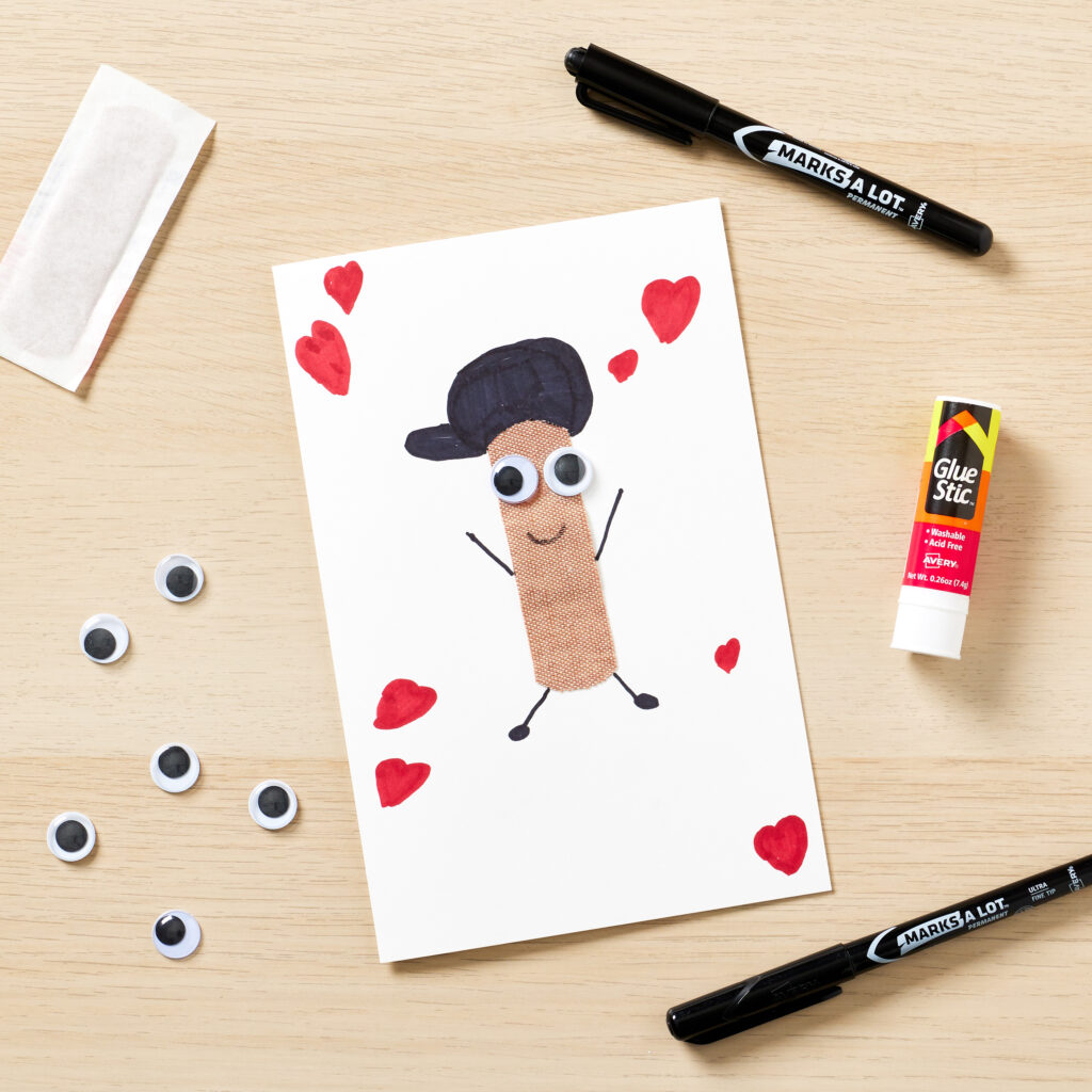 A DIY greeting card made with a blank Avery note card, glue stick, permanent marker as well as a simple adhesive bandage and googly eyes.