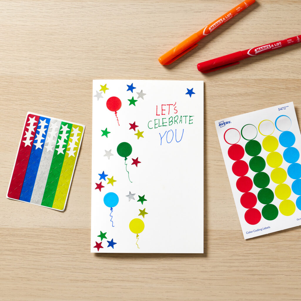 A blank Avery note card is decorated with Avery star stickers and color-coding dots as well as colorful ultrafine-tipped Avery permanent markers.
