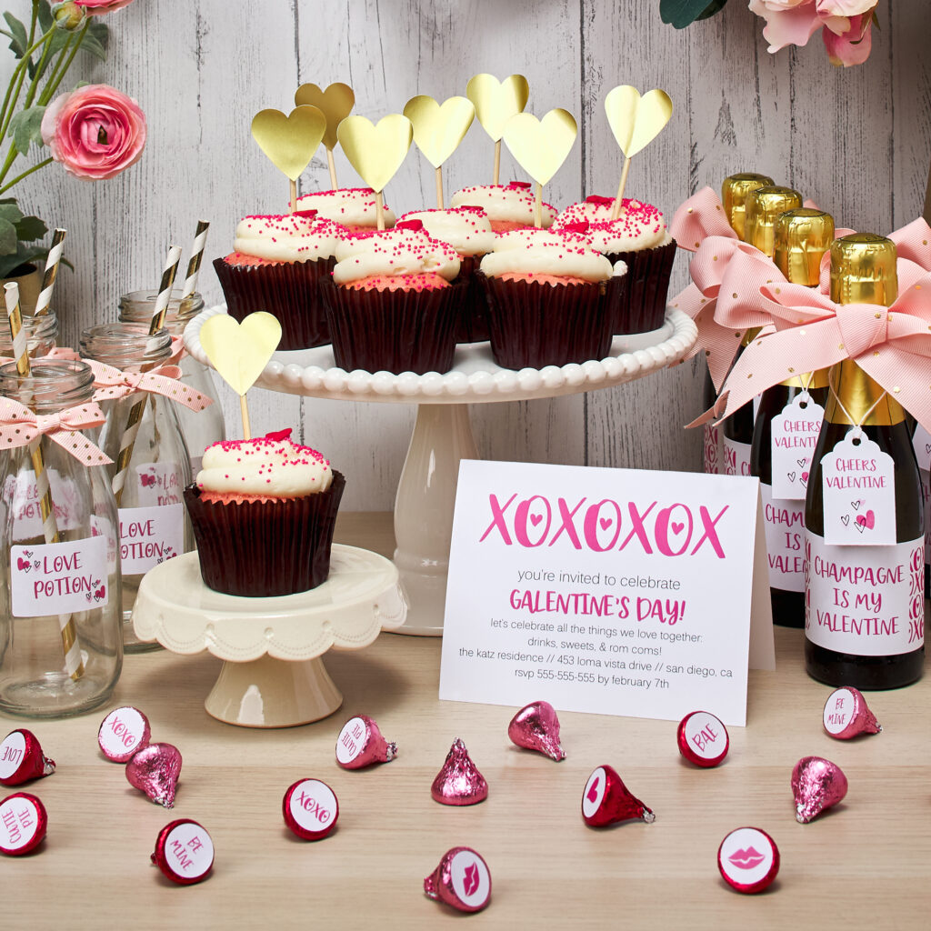 Party ideas for Galentine's day are displayed on a wooden countertop. Avery labels, cards, and tags are used to personalize the display.