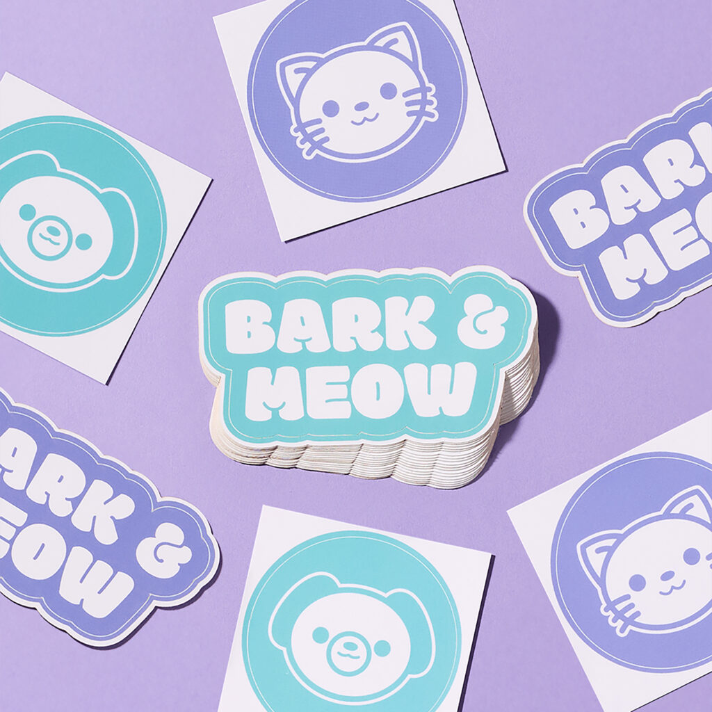 Stacks of purple and teal Bark & Meow marketing stickers featuring cat and dog illustrations on a lavender background.